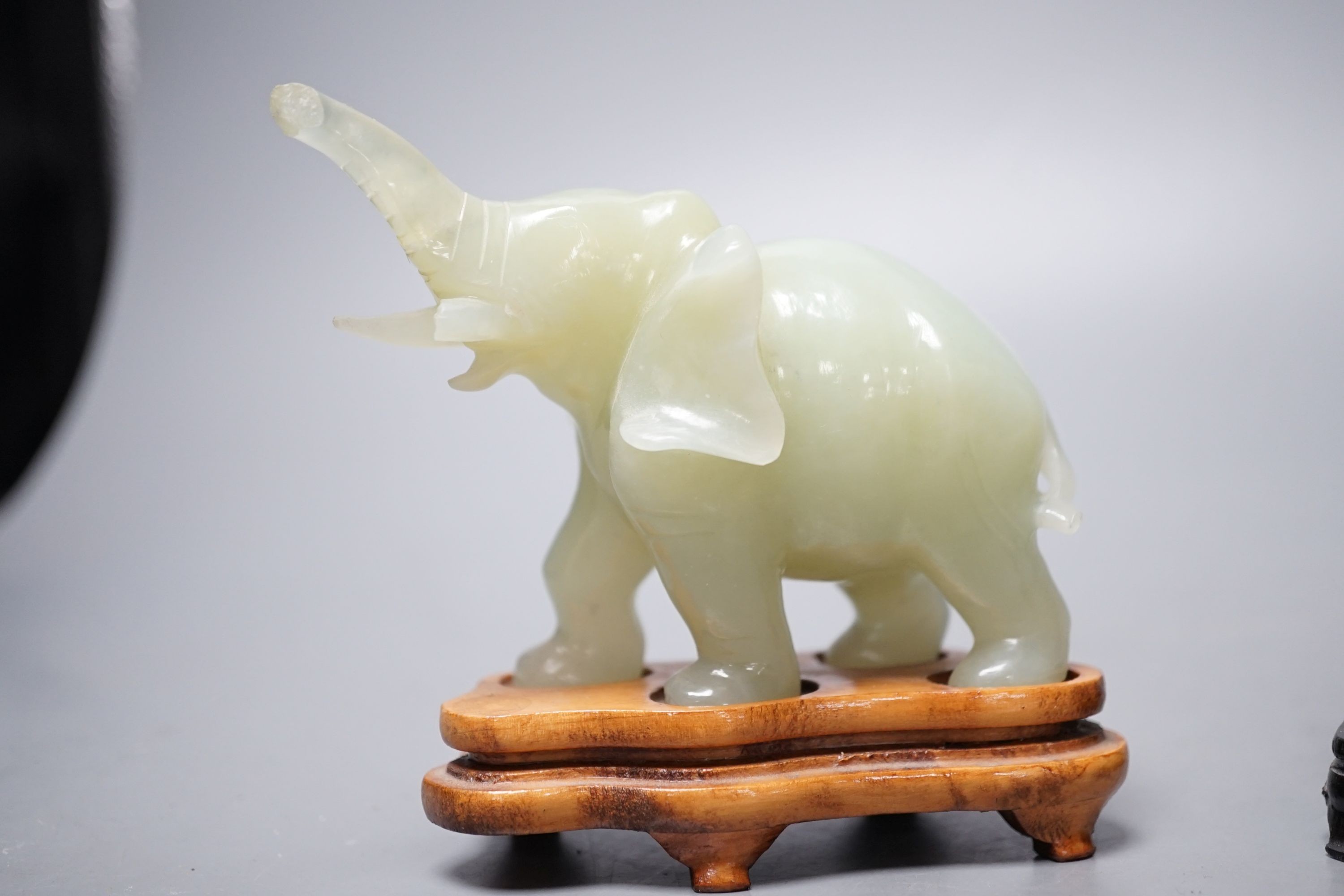 Two bowenite carvings of an elephant and Budai, wood stands, tallest, 9.5cm